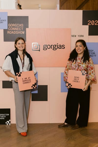 The colour-blocked Gorgias Connect Roadshow photo wall with guests and props
