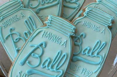 Close-up of mint iced mason jar cookies piped with Having a Ball, Since 1932