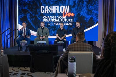 Four panelists on stage under a Cashflow Live screen reading Change Your Financial Future with Austin Zelan