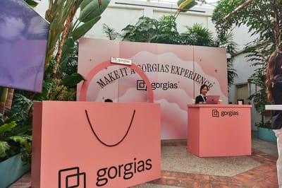 The giant Gorgias shopping bag and the check-in desk against the patterned wall