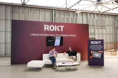A wide Rokt wall reading Unlock The Moment That Matters Most with lounge seating