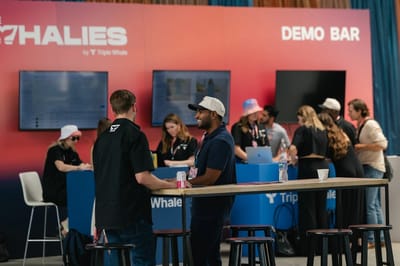 Guests at the Demo Bar counter with staff running demos on four screens