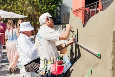 A sculptor cutting the lettering into the face of the tail by hand
