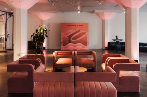 Peach velvet lounge seating in front of a 10 years of being gorgias backdrop with a large 3D 10