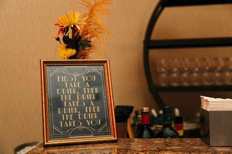 Framed sign reading First you take a drink, then the drink takes a drink, then the drink takes you
