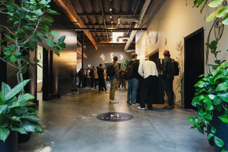 Attendees arriving along a corridor with an 8 Figure logo on the floor