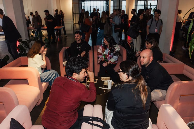 Guests sitting and talking in pink lounge chairs