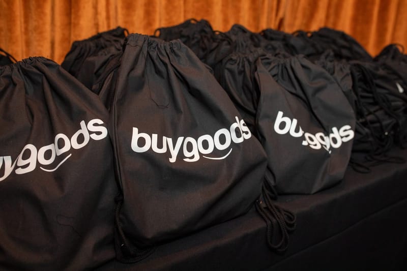 Rows of black drawstring bags printed with the buygoods logo
