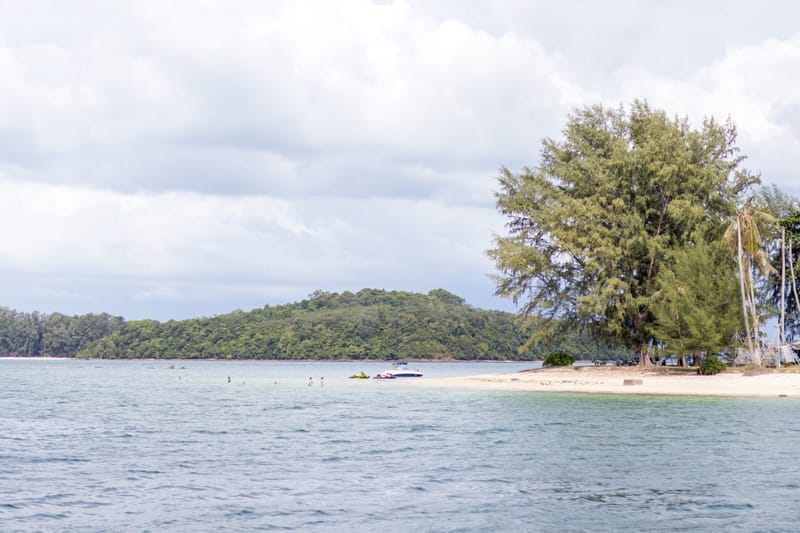 A small island with a sandbar in clear water