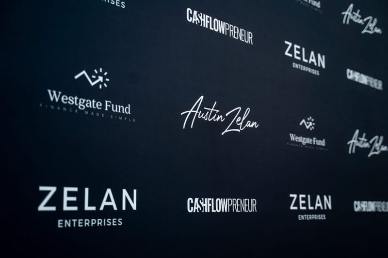Logo backdrop printed with Zelan Enterprises, Cashflowpreneur, Westgate Fund and Austin Zelan logos