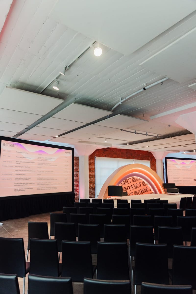 Side view of the main room with rows of black chairs and the Connect stage