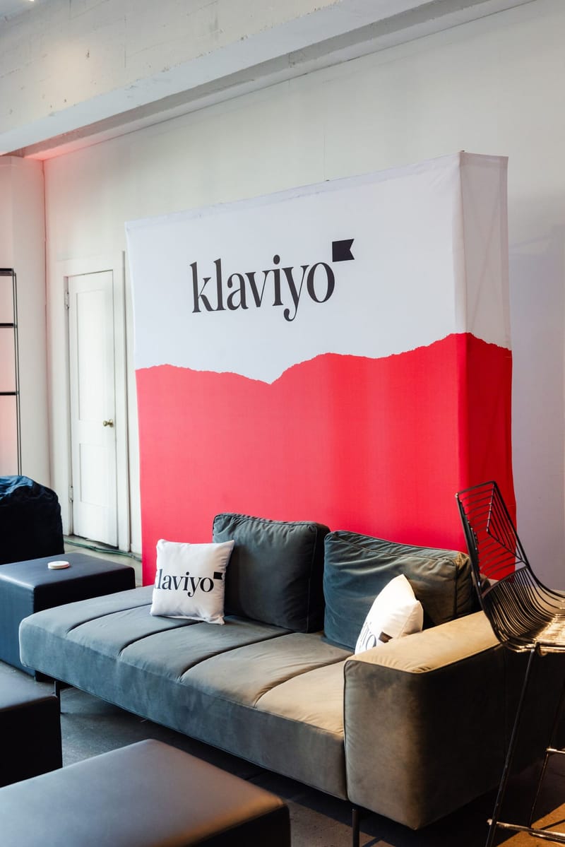 Klaviyo lounge with a grey sofa and a Klaviyo pillow
