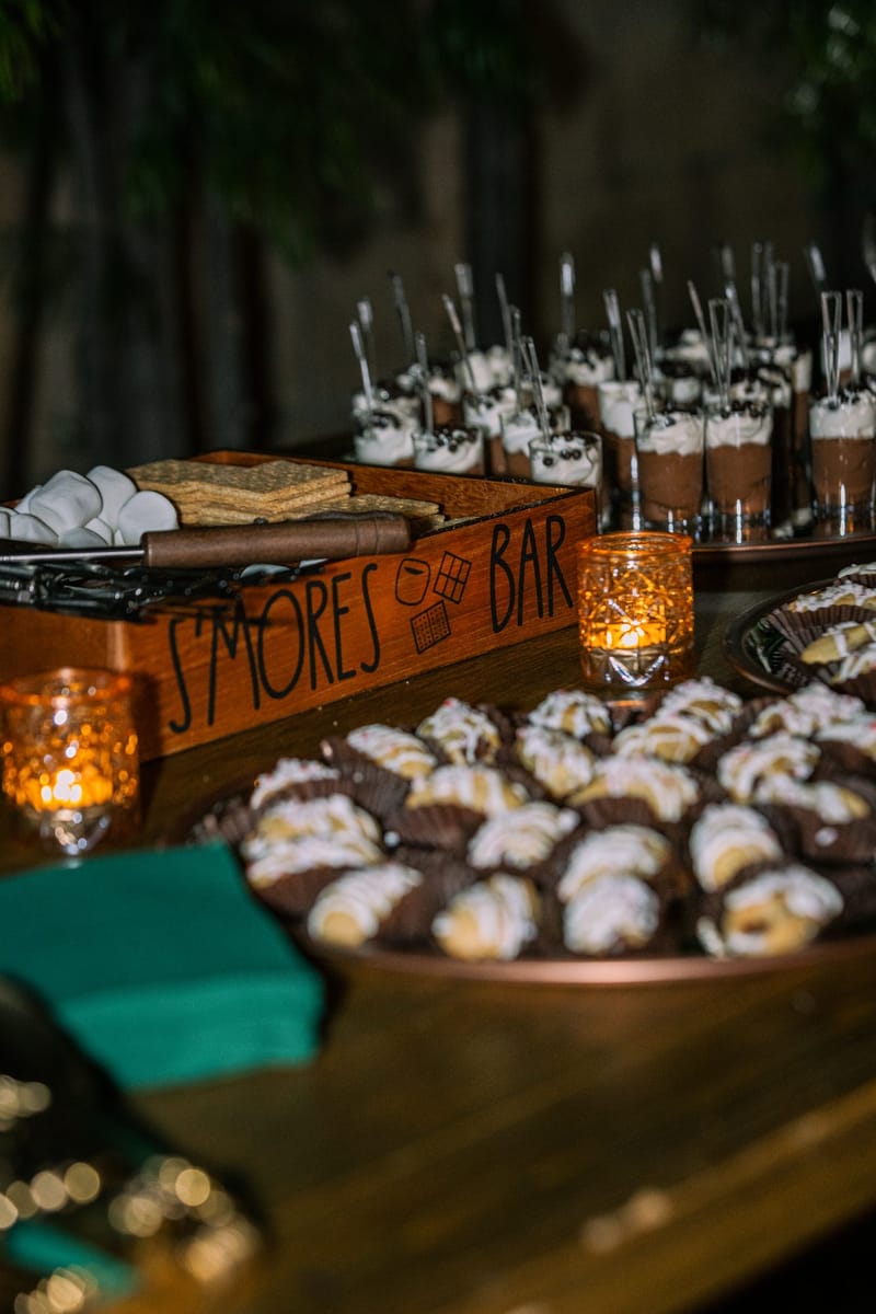 S'mores Bar crate with marshmallows and graham crackers above a tray of chocolate dipped treats