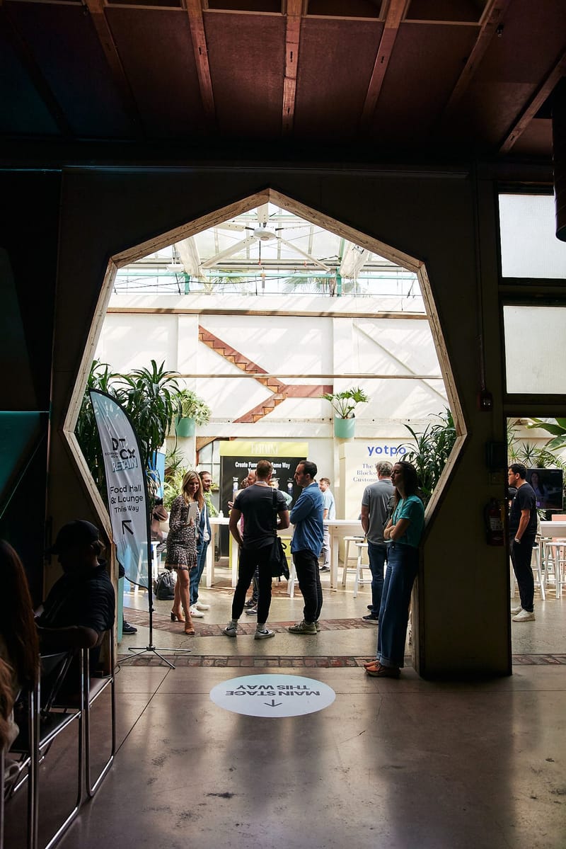 Guests seen through an angled doorway, with a Main Stage This Way floor decal