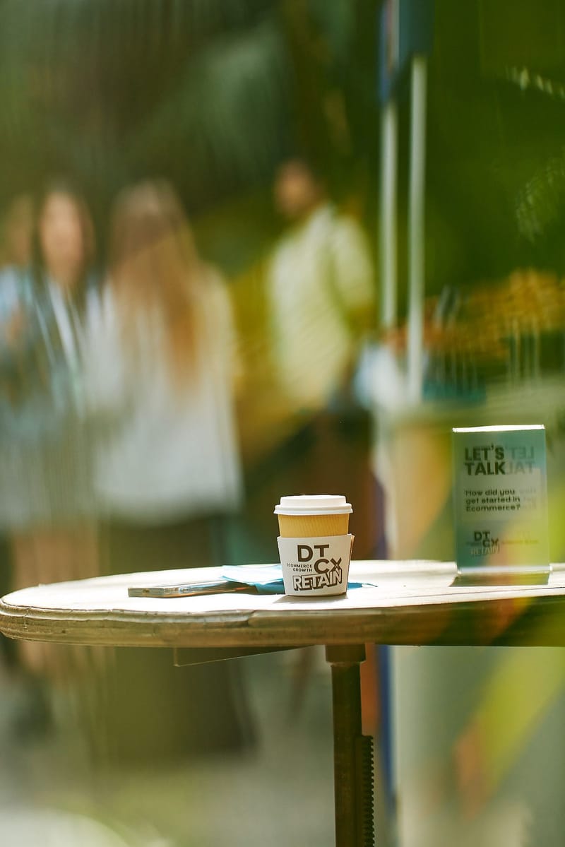 DTCx Retain coffee cup beside a Let's Talk card asking How did you get started in Ecommerce?
