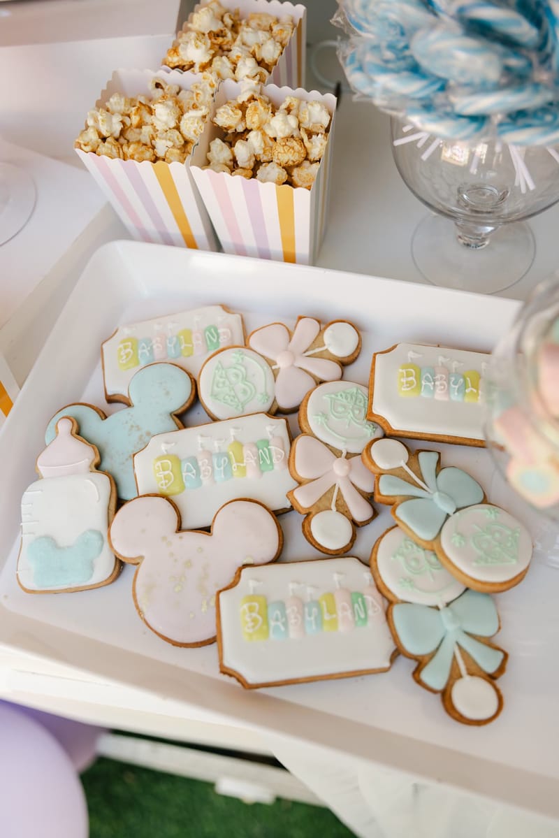 Tray of iced cookies shaped like Mickey heads, baby bottles and bows
