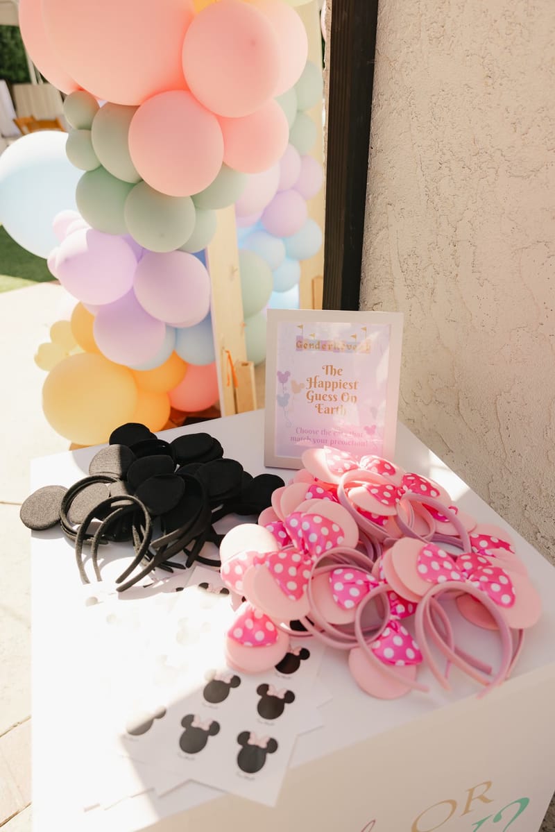 Mickey ear headbands and pink polka dot Minnie bows laid out for guests