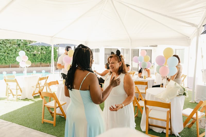 Guests talking under the white tent