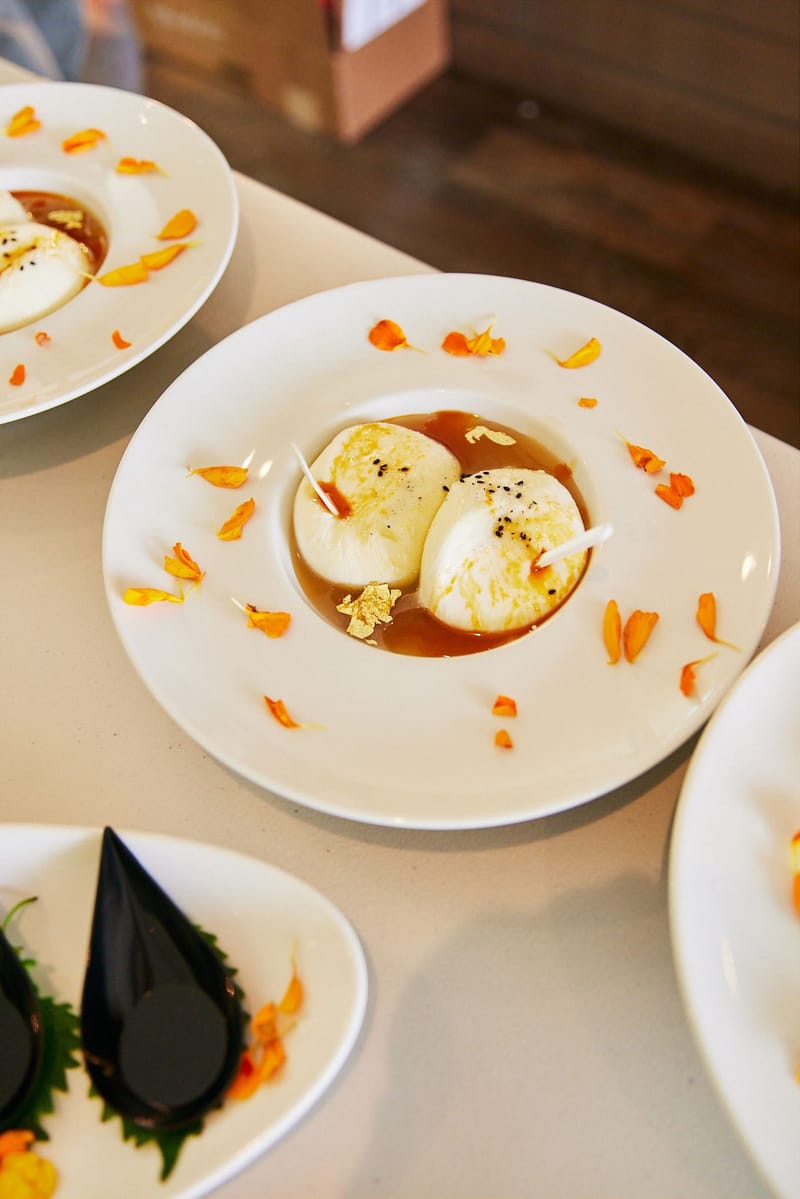 A white cheese dish scattered with orange flower petals
