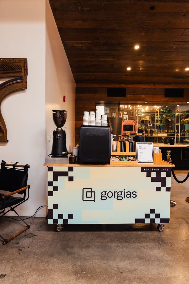 Gorgias coffee cart with checkerboard trim, a grinder and stacked cups