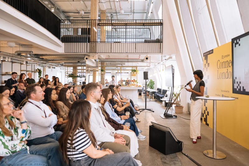 A speaker with a microphone addressing a seated audience at Gorgias Connect London