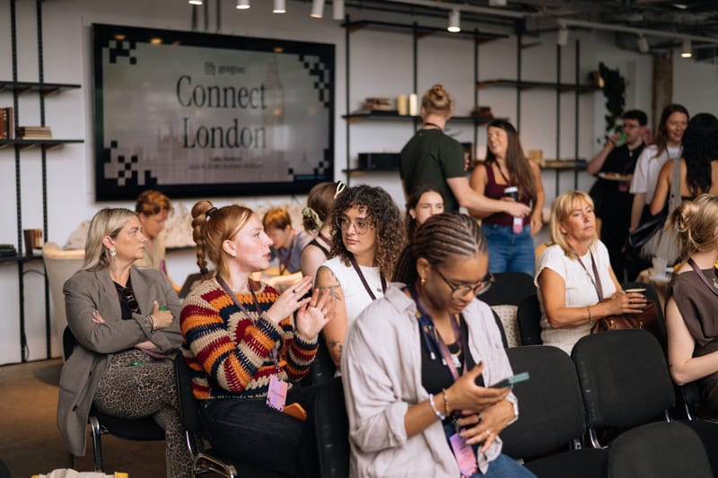 Guests seated and talking in front of the Gorgias Connect London screen