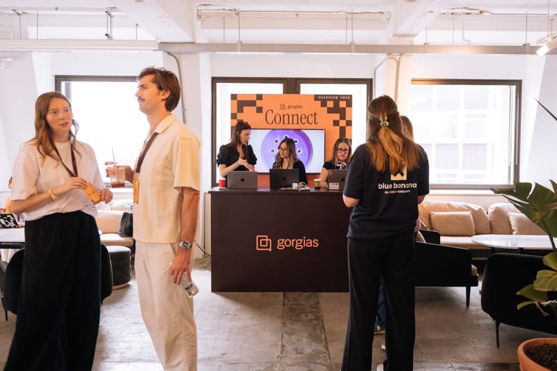 Guests talking beside the Gorgias check-in desk