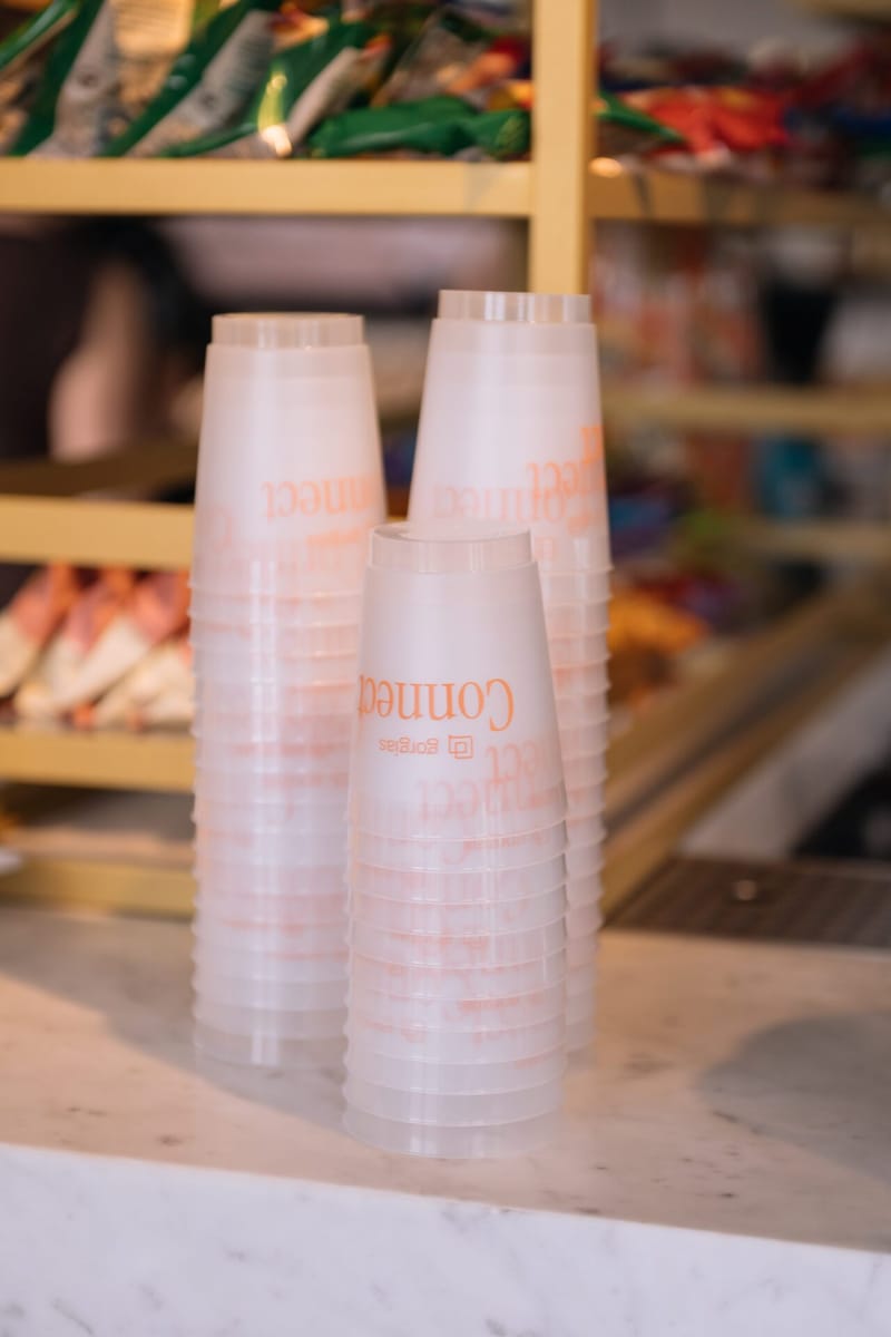 Stacks of frosted cups printed with the Connect logo