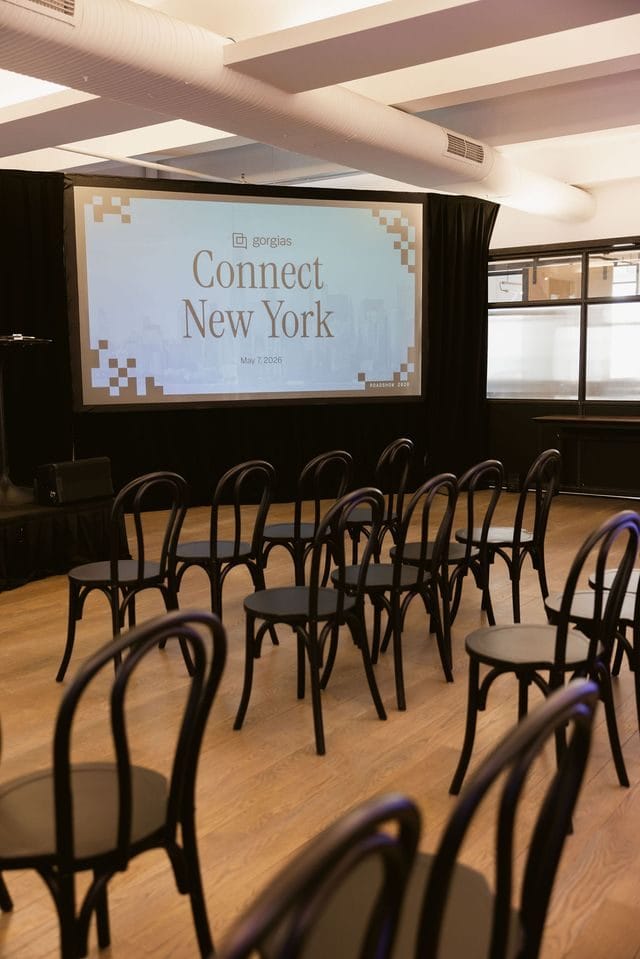 Rows of black bentwood chairs facing a screen reading Gorgias Connect New York