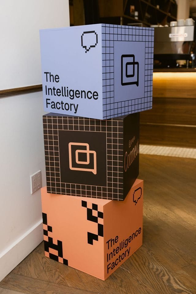 Stacked cubes printed with The Intelligence Factory and small Gorgias icons