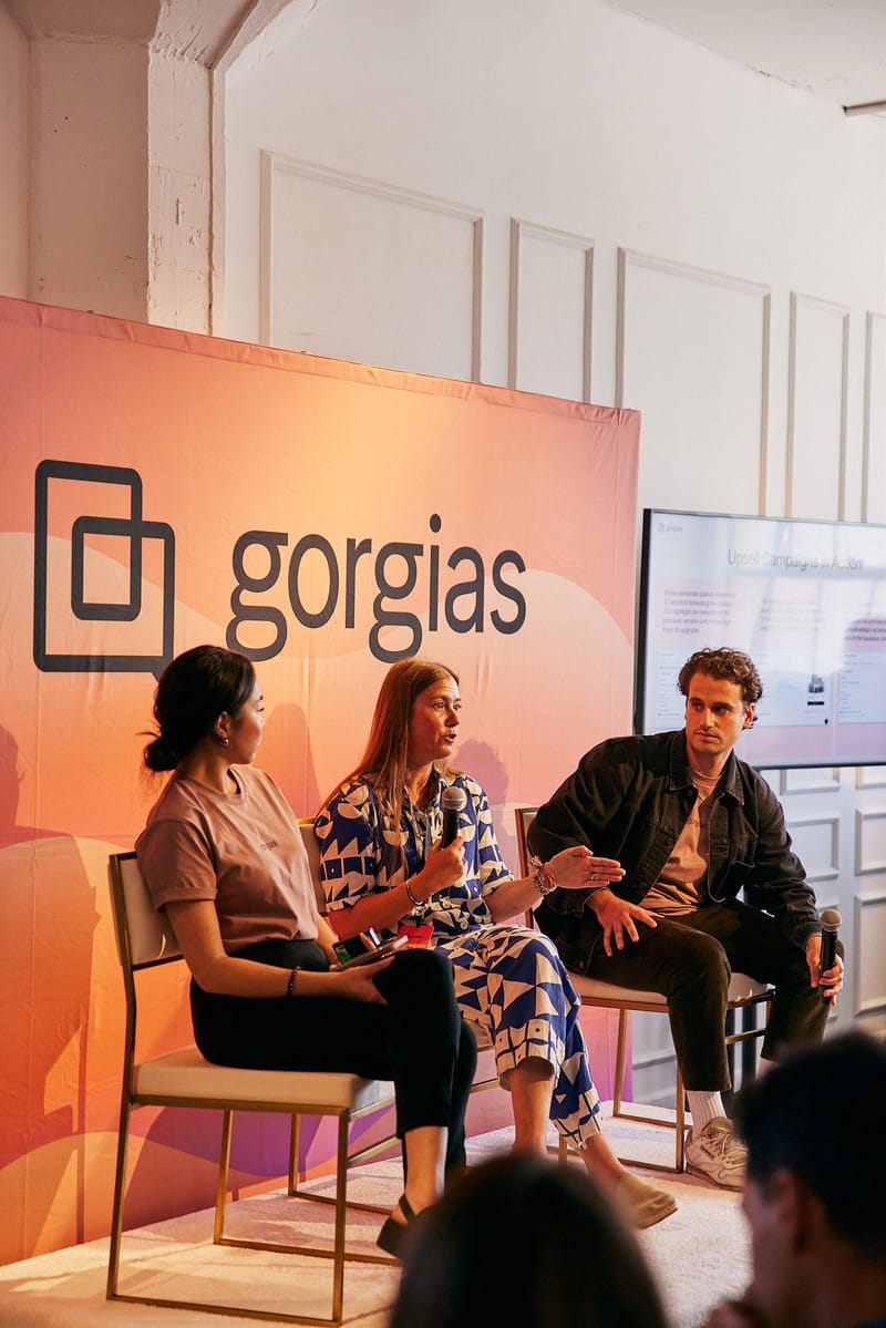 Three panelists in conversation in front of a Gorgias backdrop