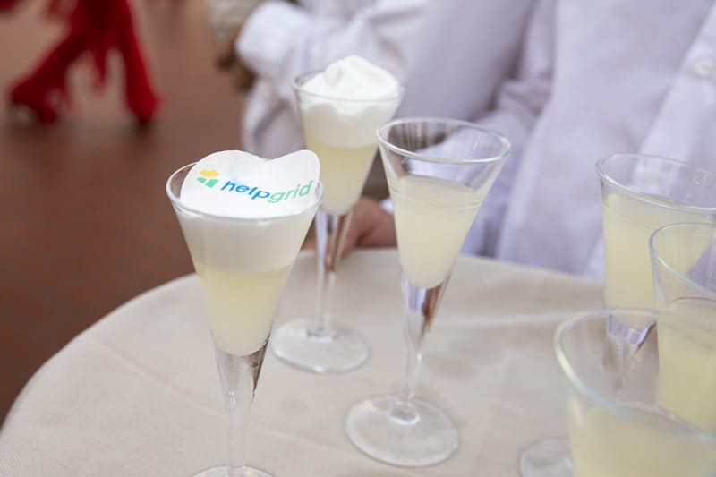 Foam-topped cocktails, one with the HelpGrid logo printed on the foam