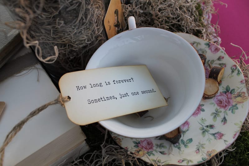 Floral teacup holding a tag reading How long is forever? Sometimes, just one second.