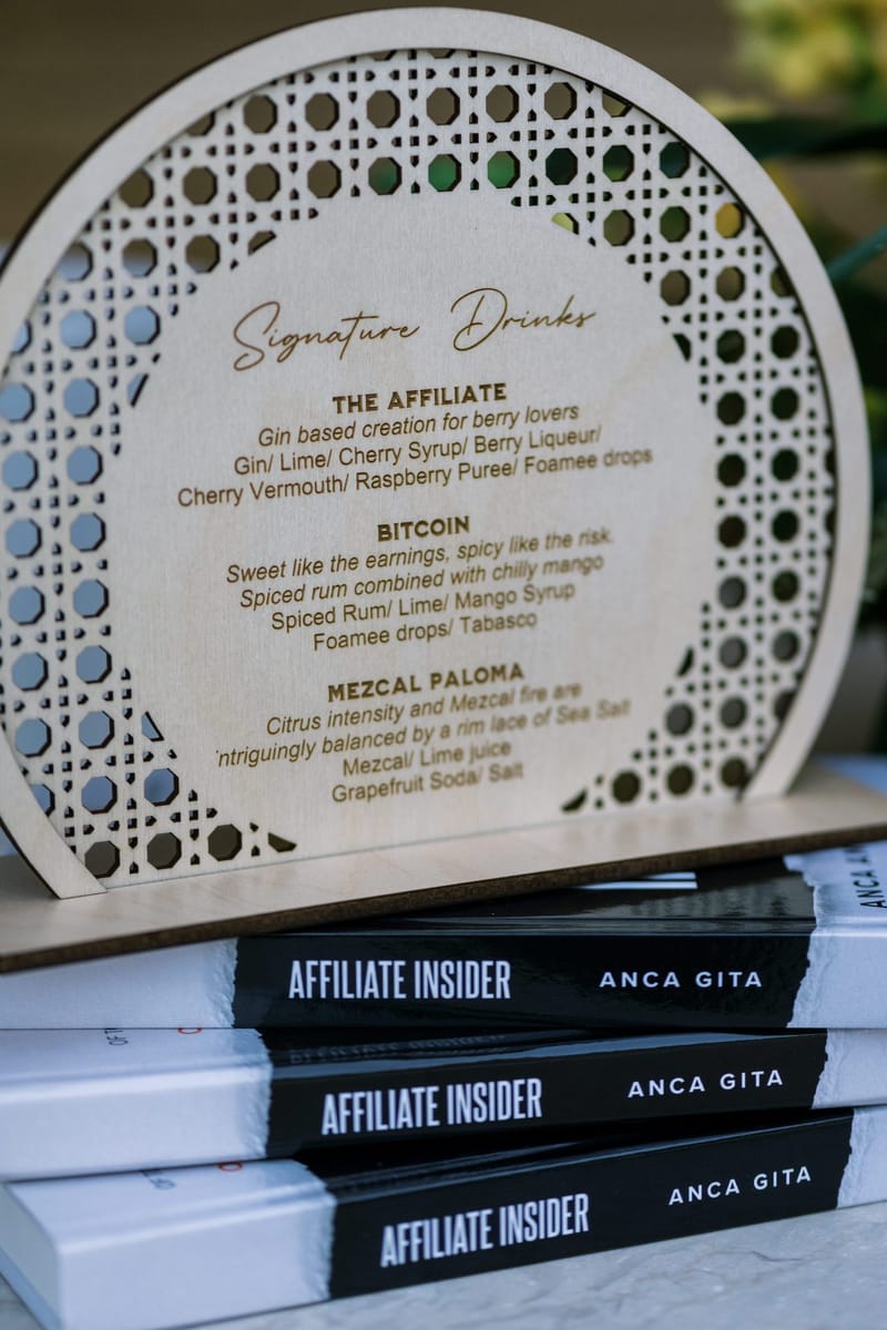 Wooden Signature Drinks sign listing The Affiliate, Bitcoin and Mezcal Paloma on Affiliate Insider books