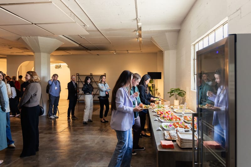 Guests serving themselves at a buffet in an industrial loft