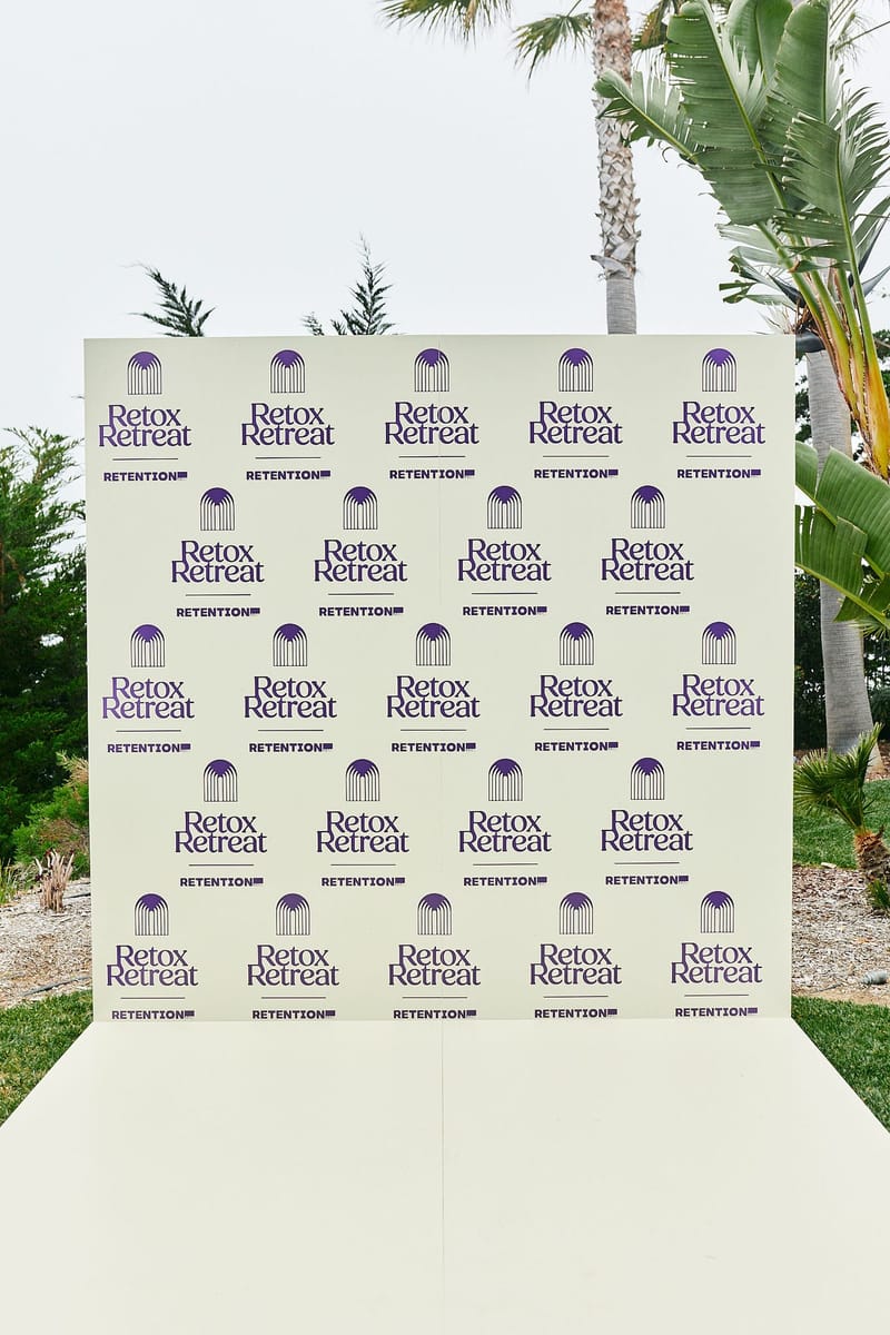 Retox Retreat and Retention logo backdrop standing on a white platform among palms