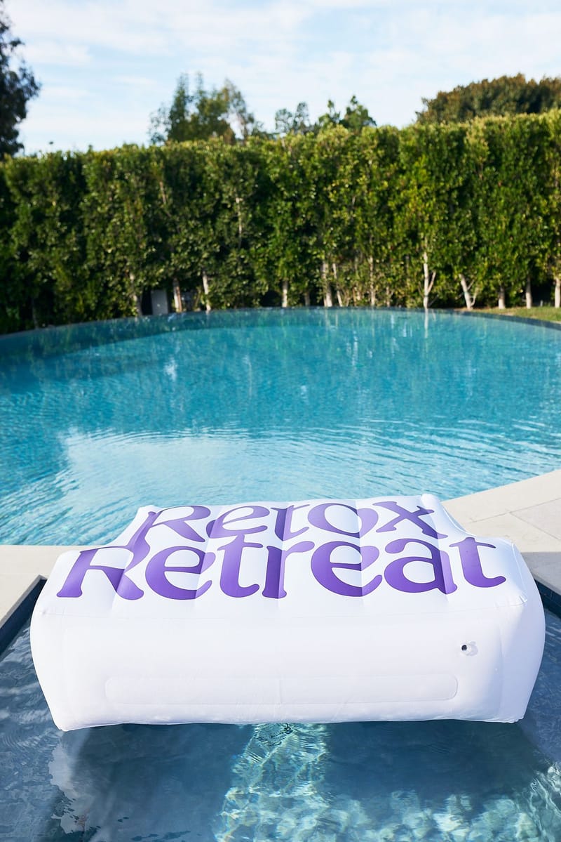 Inflatable Retox Retreat float on the pool, with tall hedges behind