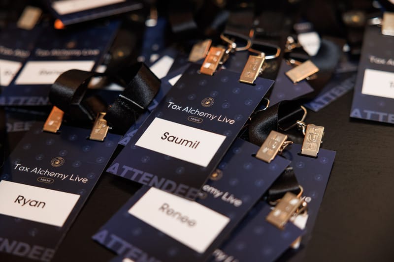 Personalized Tax Alchemy Live attendee name badges with lanyards spread across a table