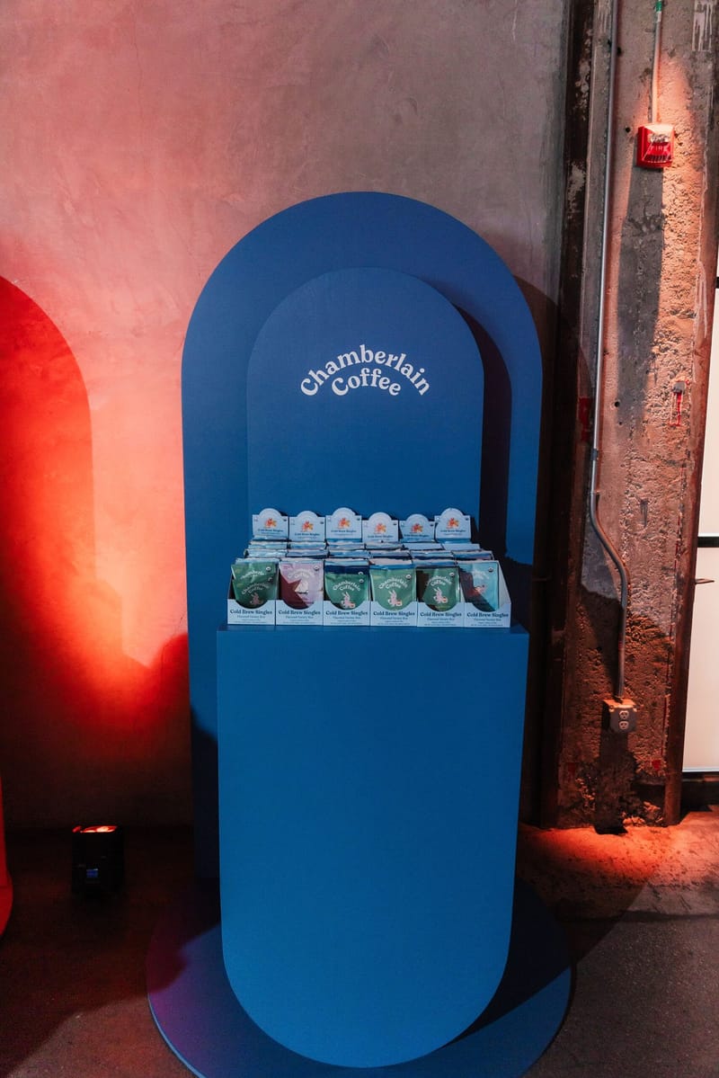Blue arch-shaped Chamberlain Coffee display holding boxed products under warm lighting