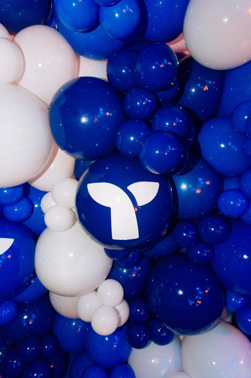 Close view of blue and white balloons, one printed with the Triple Whale logo