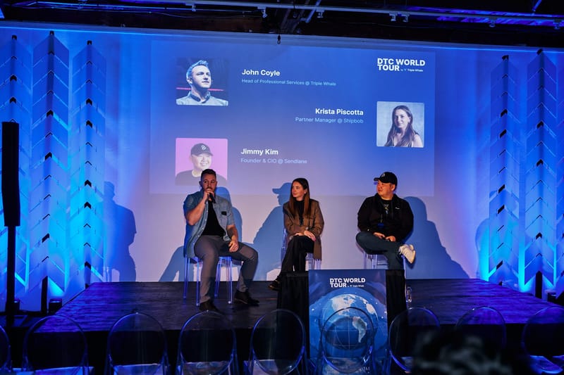 Panel under a screen naming John Coyle of Triple Whale, Krista Piscotta of Shipbob and Jimmy Kim of Sendlane