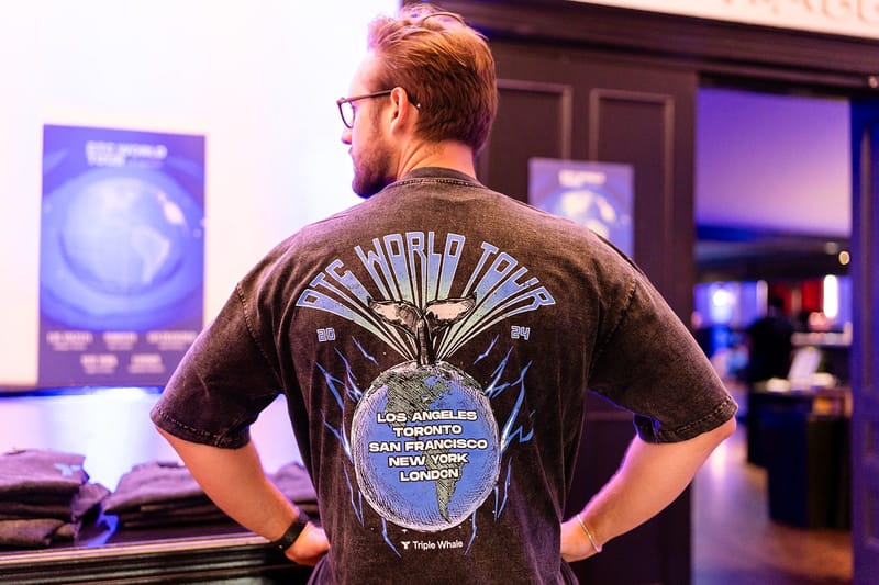 Guest seen from behind in a DTC World Tour 2024 shirt listing Los Angeles, Toronto, San Francisco, New York, London