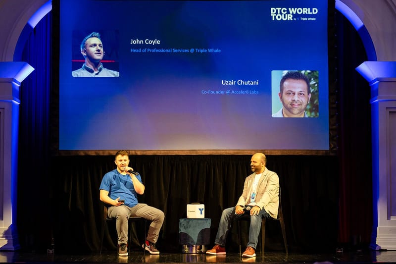 Two panelists on stage under a screen naming John Coyle of Triple Whale and Uzair Chutani of Acceler8 Labs