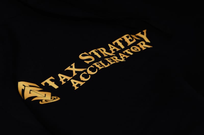 Close view of the gold Tax Strategy Accelerator logo on black fabric